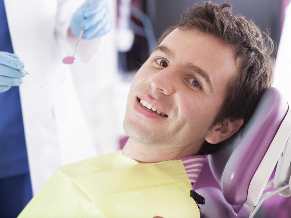 man sitting in dental chair